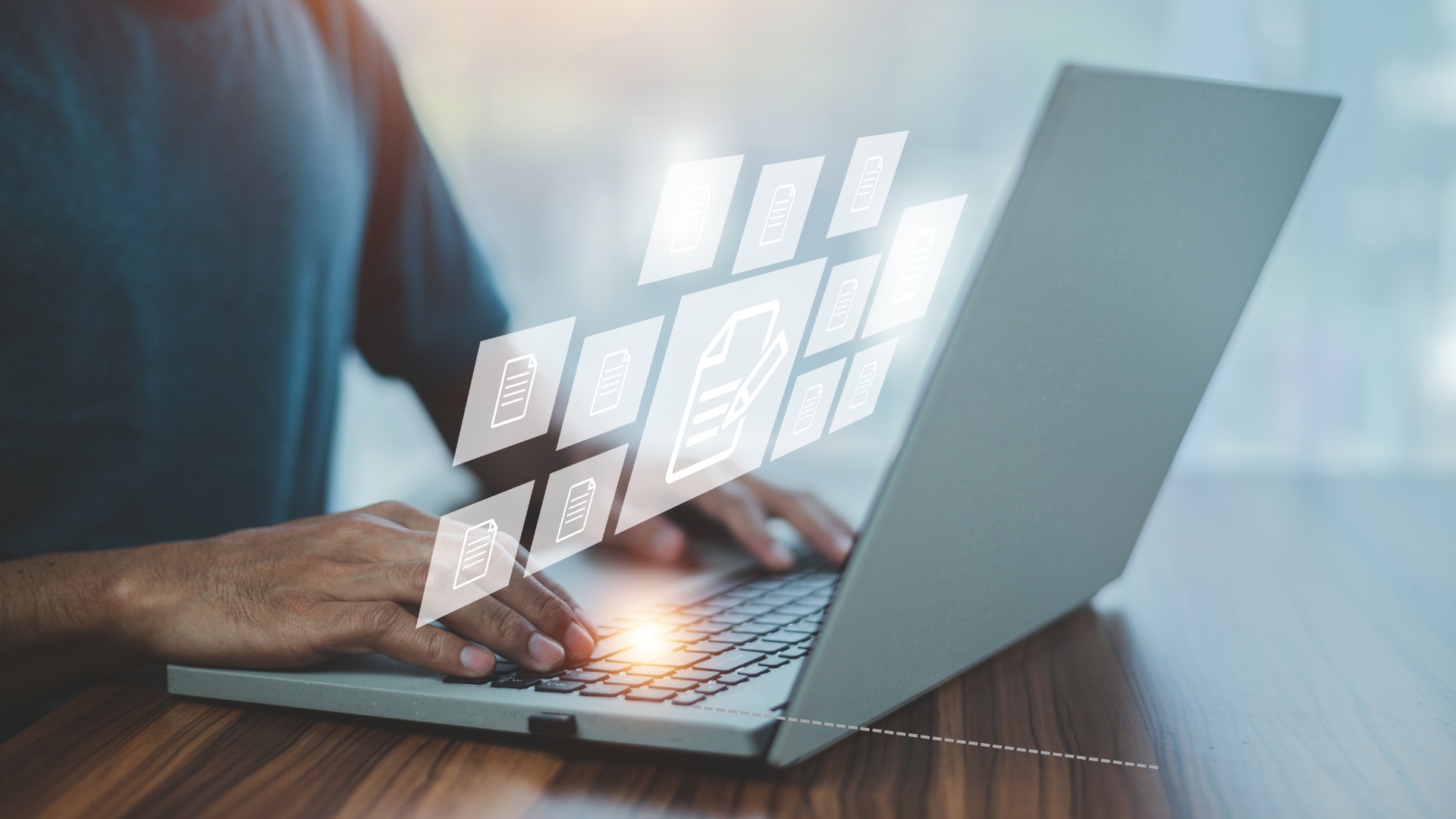 Zdjęcie przedstawia osobę pracującą przy laptopie. Z komputera 